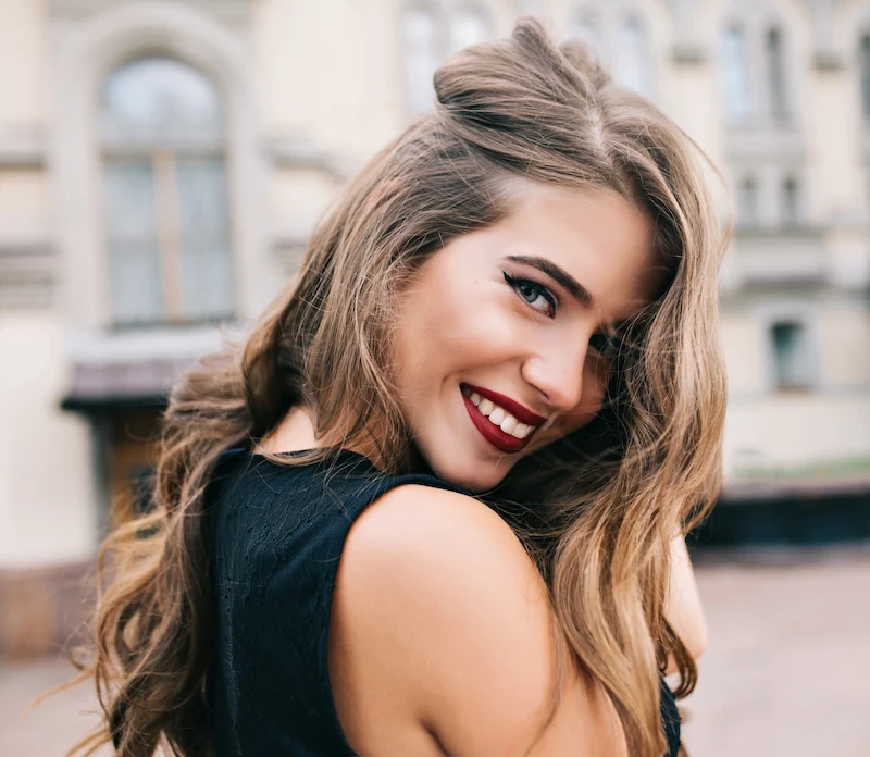 Beautiful woman with red lipstick smiling