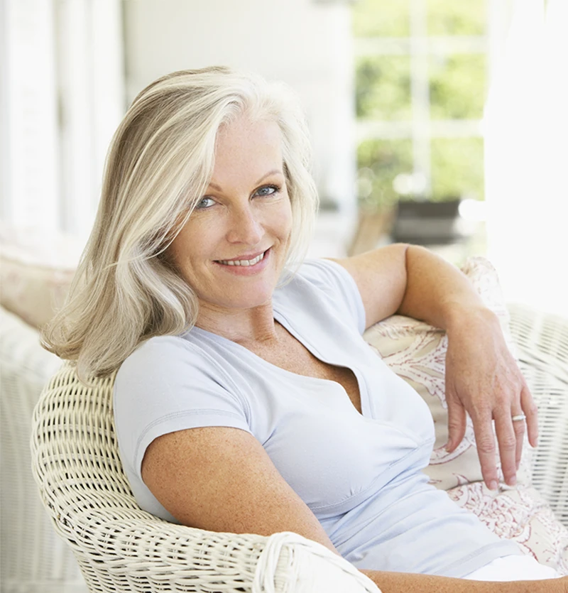 Attractive middle aged woman relaxing in chair