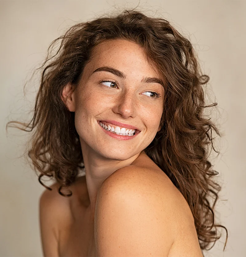 Portrait of smiling woman with curly hair